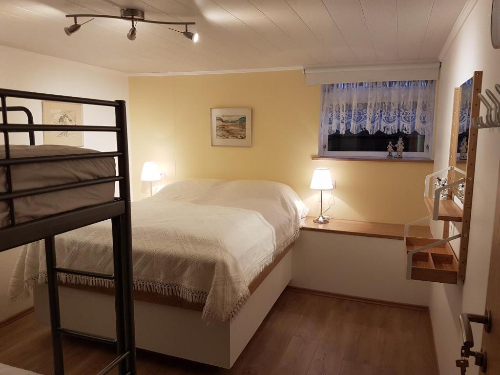 a bedroom with a bunk bed and a window at Holiday Guesthouse in Stykkishólmur