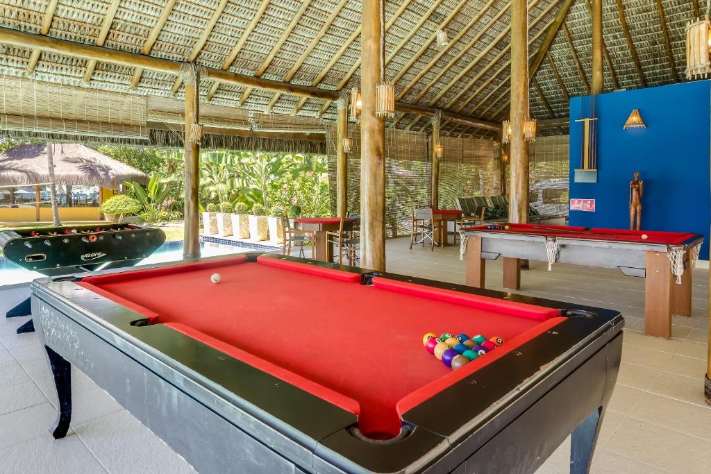 a pool table with balls on top of it in a room at Villa dos Corais in Morro de São Paulo