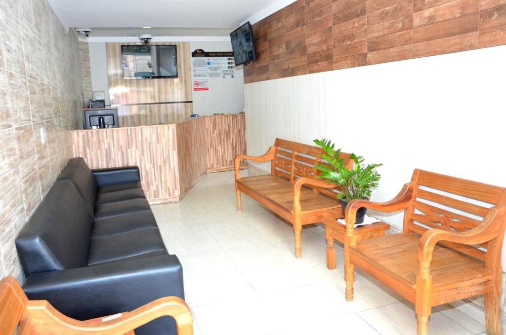 a living room filled with furniture and a wooden floor at Hotel Cerrado in Goiânia