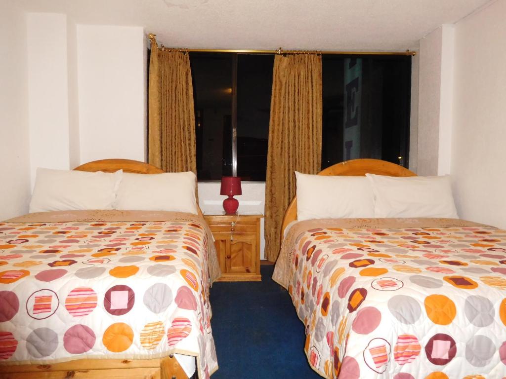 Postel nebo postele na pokoji v ubytování Hostal Alborada Riobamba