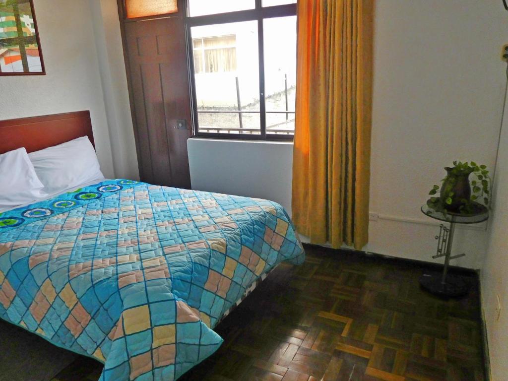 Postel nebo postele na pokoji v ubytování Hostal Alborada Riobamba