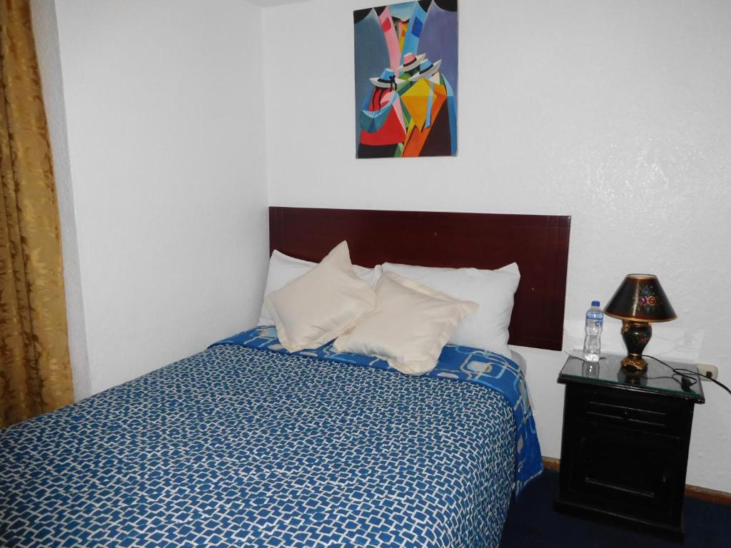 Postel nebo postele na pokoji v ubytování Hostal Alborada Riobamba