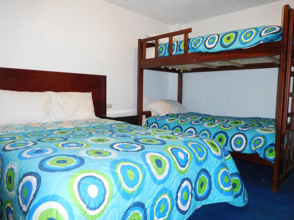 Postel nebo postele na pokoji v ubytování Hostal Alborada Riobamba