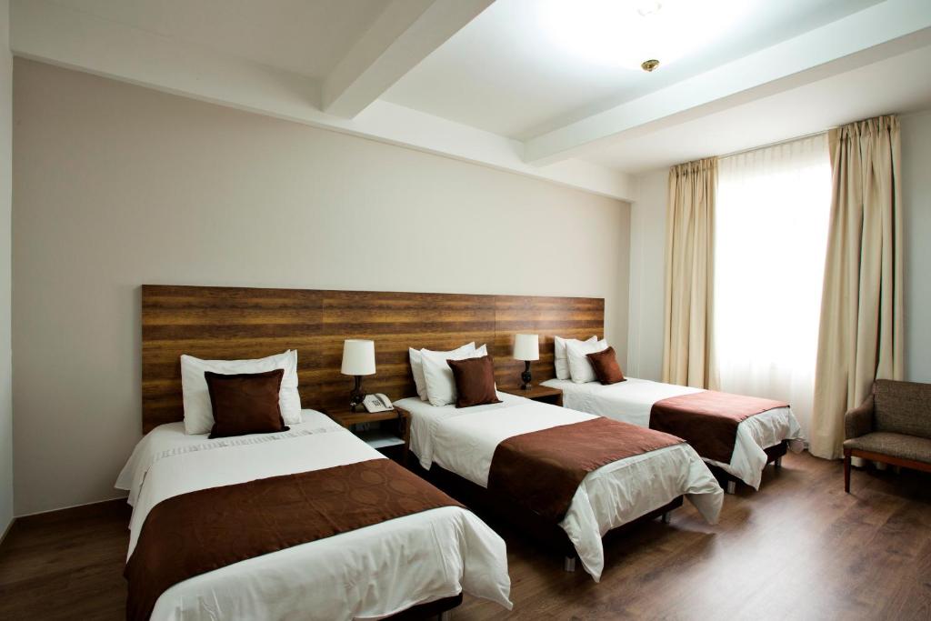 Postel nebo postele na pokoji v ubytování Hotel Nutibara