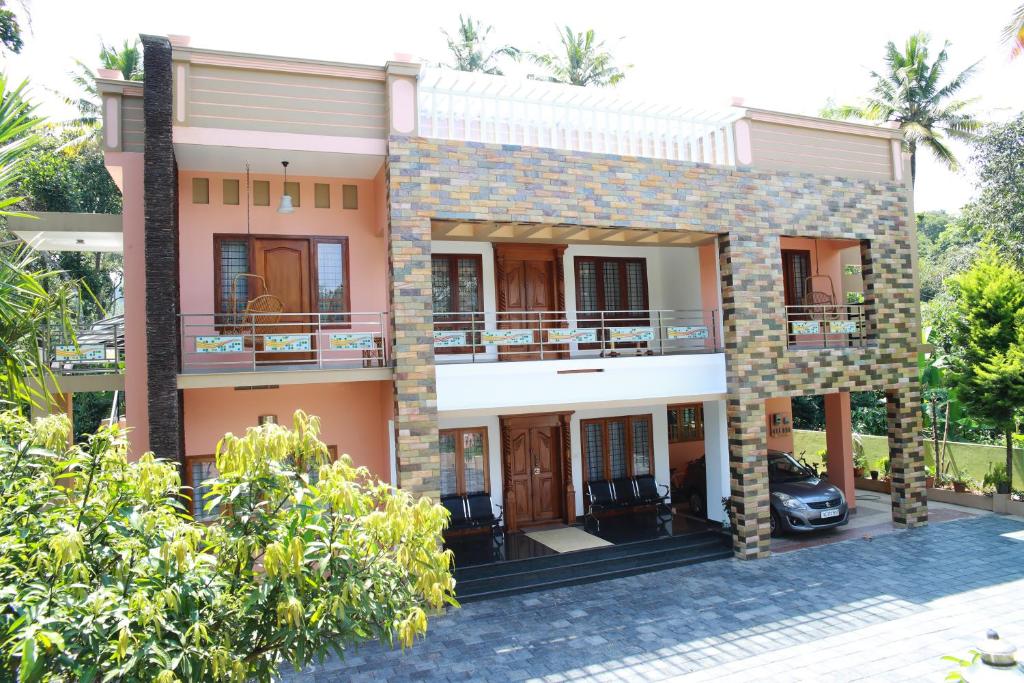 a house with a car parked in front of it at Periyar Villa Home Stay - Thekkady in Thekkady