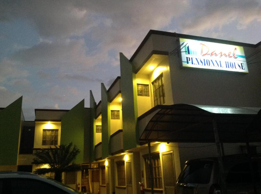 a building with a sign on the side of it at Danel Pensionne House in Tacloban