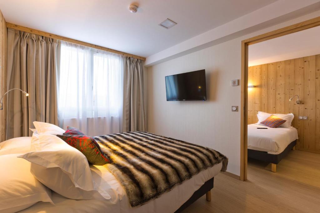 Postel nebo postele na pokoji v ubytování Hôtel restaurant Spa de l'Abbaye