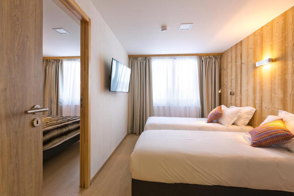 Postel nebo postele na pokoji v ubytování Hôtel restaurant Spa de l'Abbaye