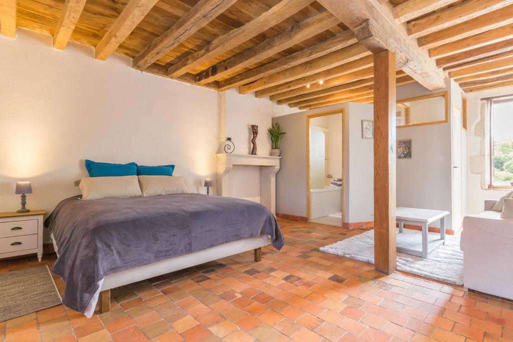 a bedroom with a large bed in a room at Moulin de Janlard in Nannay