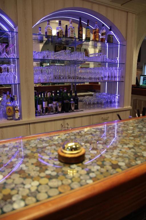a bar with a counter with blue lights on it at Hotel Gasthof Goldener Hahn in Frankfurt Oder