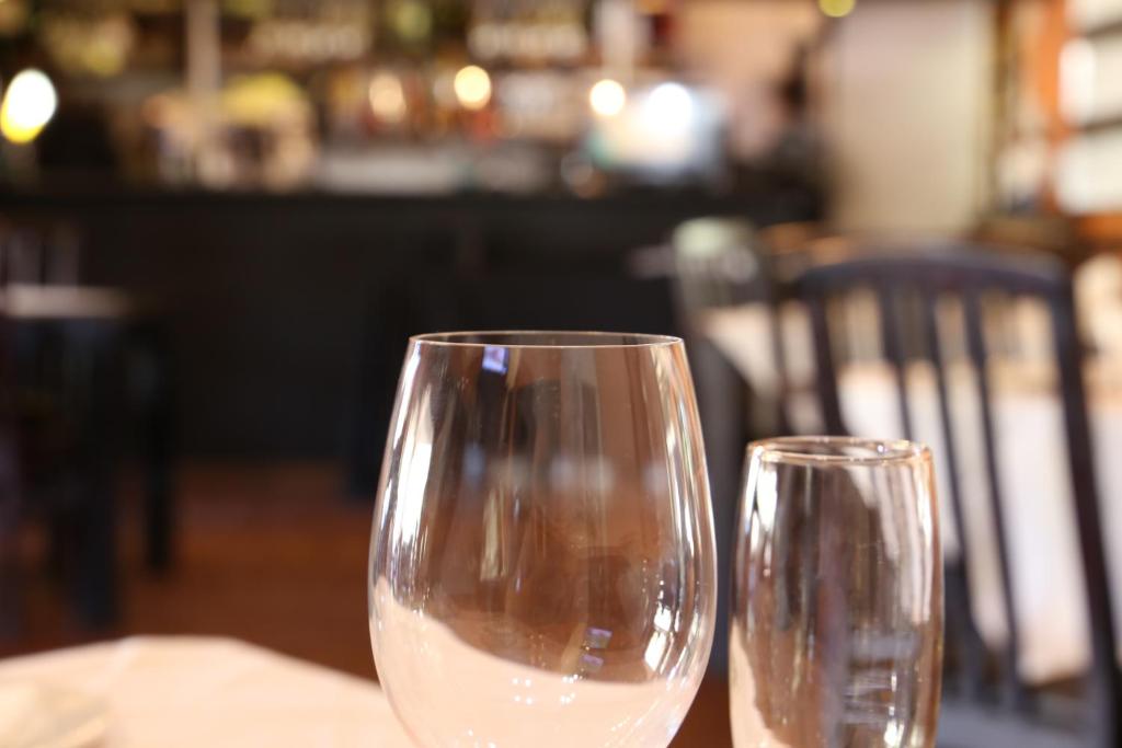 two glasses of white wine sitting on a table at Klein Windhoek Guesthouse in Windhoek