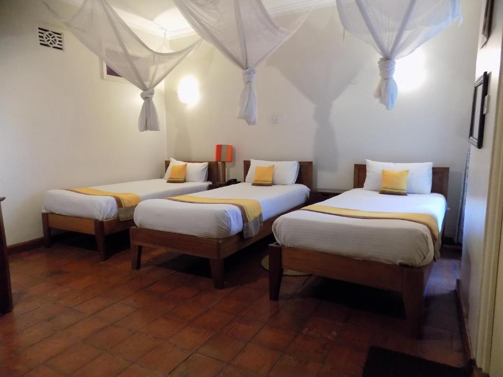 Postel nebo postele na pokoji v ubytování Kenya Comfort Hotel