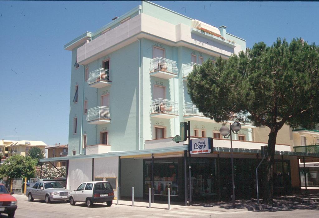 a blue building with cars parked in front of it at Condominio York in Lido di Jesolo