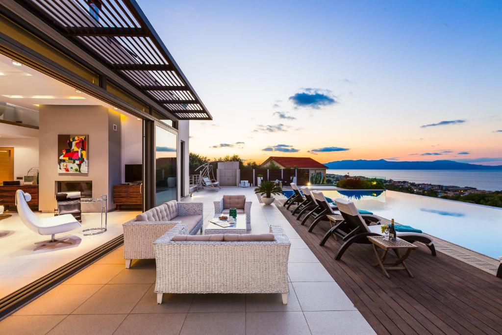 an outdoor living room with a view of the ocean at Winehill Villa in Platanias