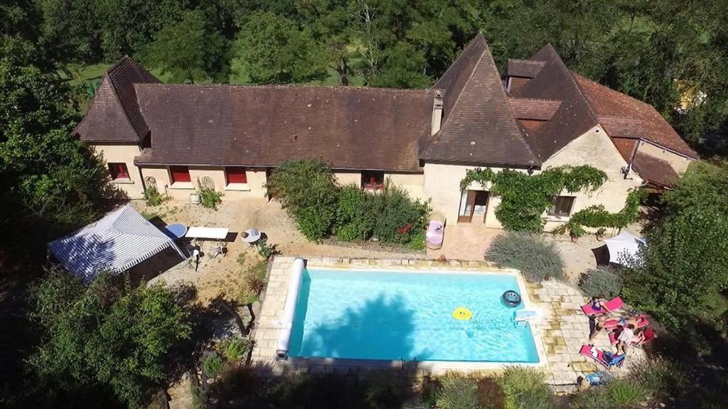 an aerial view of a house with a swimming pool at Les Deux Tours in Siorac-en-Périgord