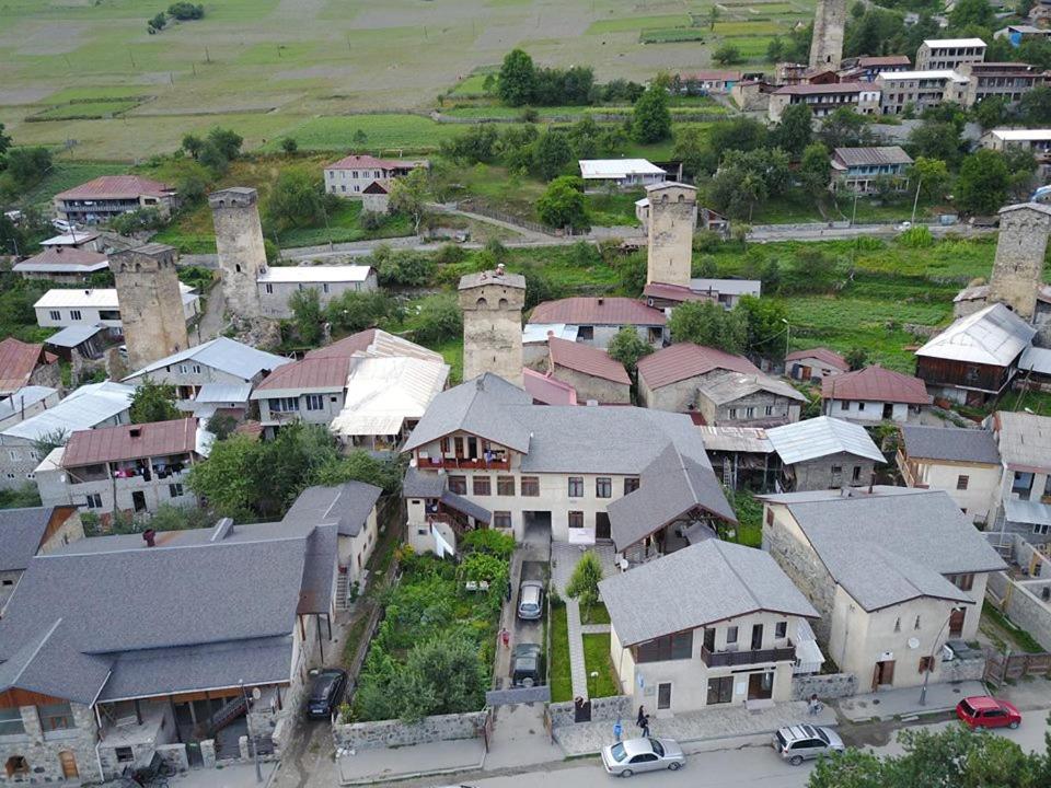 an aerial view of a village with houses and cars at N&N Guest House in Mestia