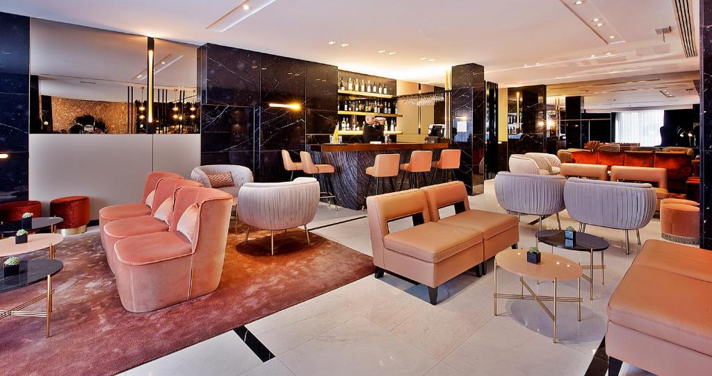 A polished lobby lounge with a built-in bar and upholstered seating.