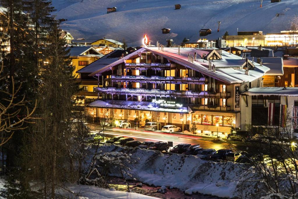 a hotel in the middle of a city at night at Raffl's St. Antoner Hof in Sankt Anton am Arlberg