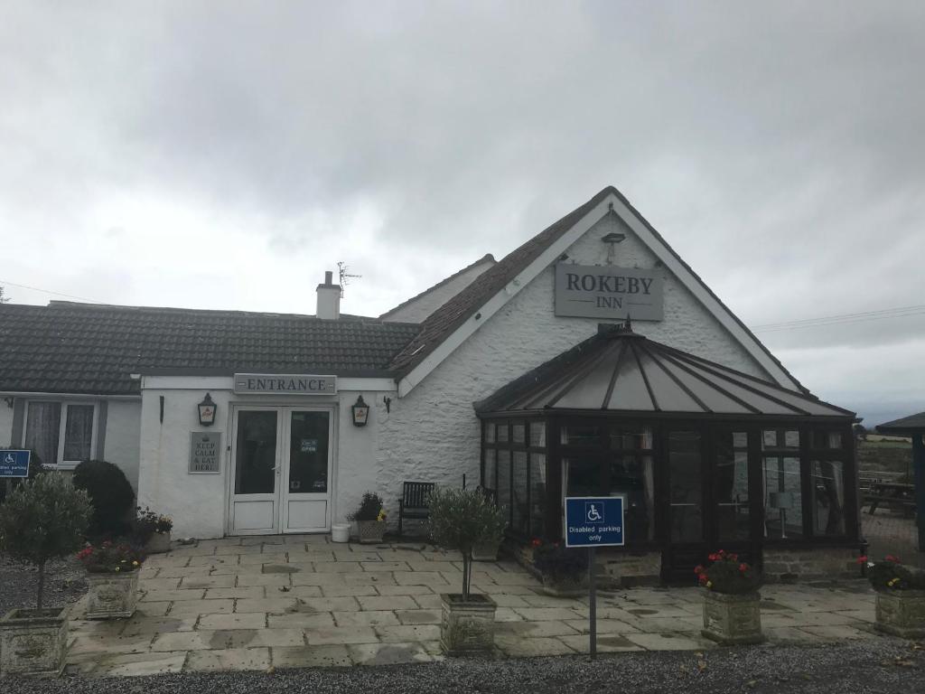 a house with a sign on the front of it at Rokeby Inn in Newsham