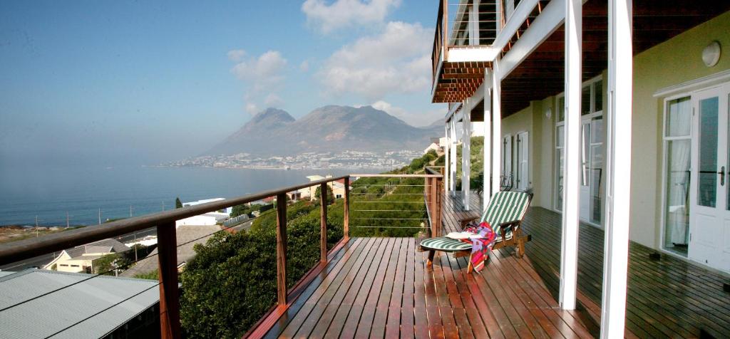 a balcony of a house with a view of the ocean at Moonglow Guesthouse in Simonʼs Town