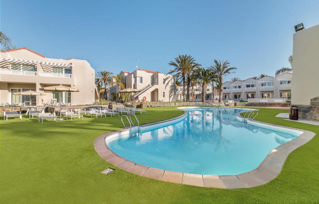 a large swimming pool in the middle of a resort at Hotel LIVVO Koala Garden in Maspalomas