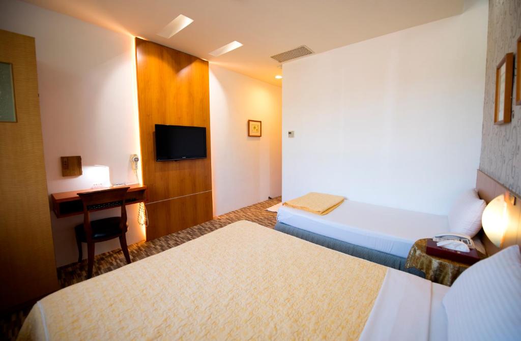 Postel nebo postele na pokoji v ubytování Songyuan B&B