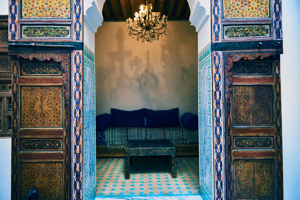 an entrance to a room with a couch and a chandelier at Dar Saida in Fez