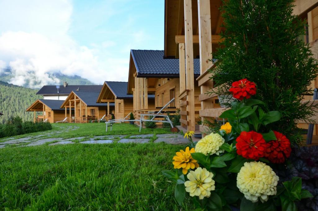 a house with flowers in front of it at Alpenchalets Mair in Sesto