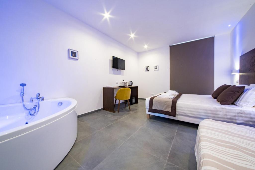 Postel nebo postele na pokoji v ubytování Hotel Assisivm Antica Dimora AD