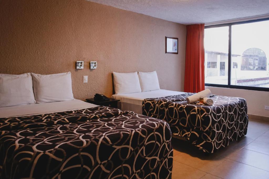 Postel nebo postele na pokoji v ubytování Hotel Colon Merida