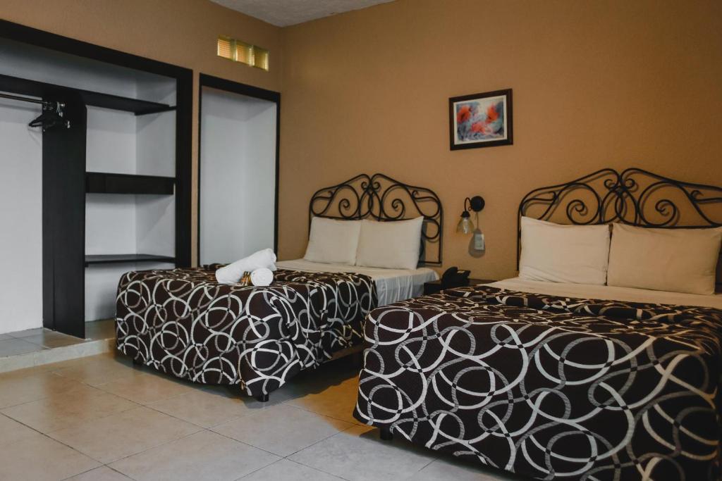 Postel nebo postele na pokoji v ubytování Hotel Colon Merida