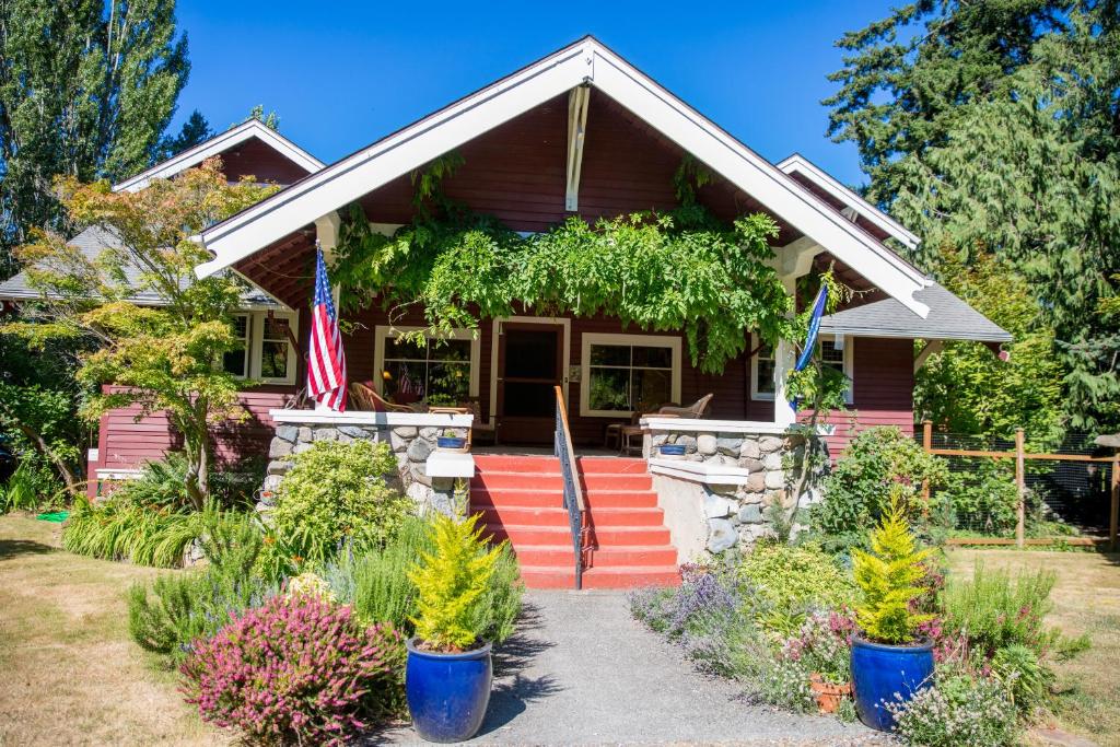 a house with an american flag in front of it at Kangaroo House Bed & Breakfast in Eastsound