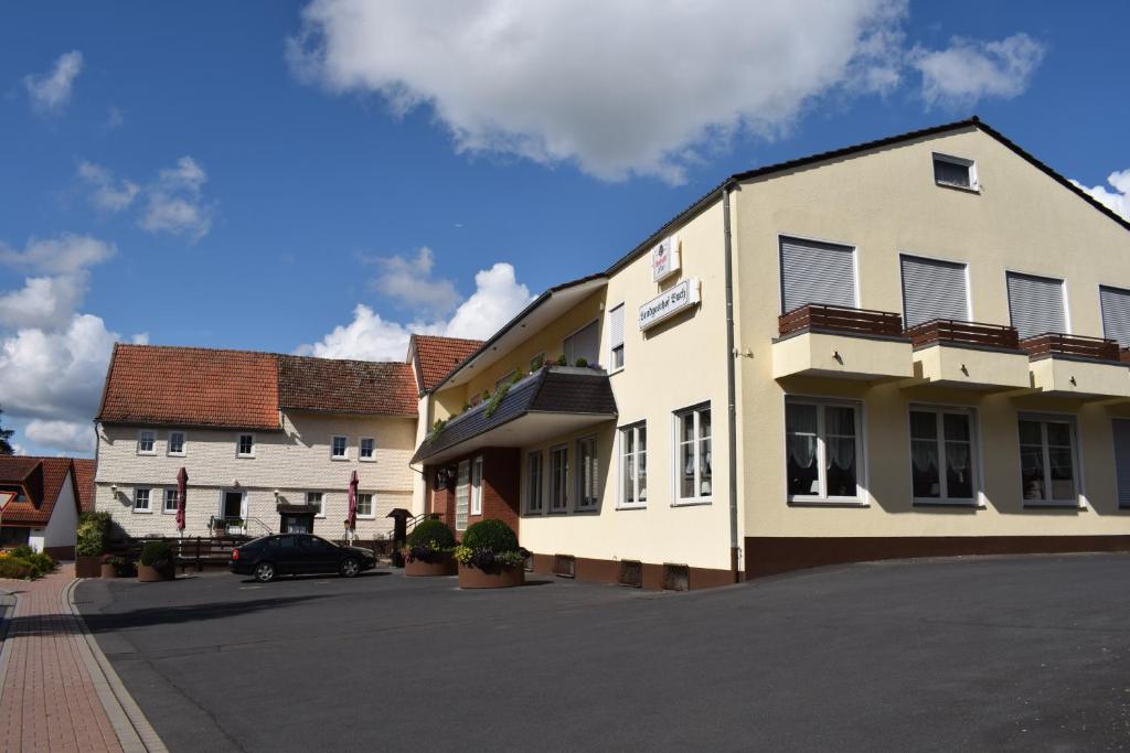 a building with a car parked in front of it at Landgasthof Buch in Eichenzell