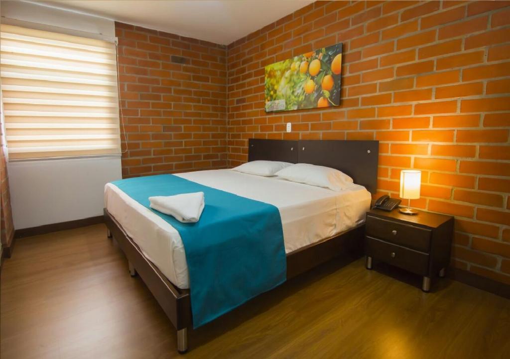 Postel nebo postele na pokoji v ubytování Hotel Valle de San Nicolas
