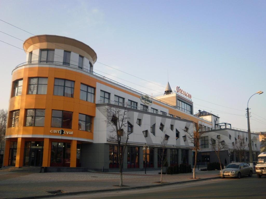an orange and white building on a city street at Apelsin apartment in Bila Tserkva