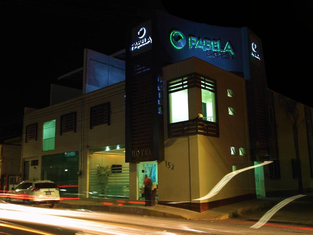 a building on a city street at night at Hotel Pabela in Ocotlán