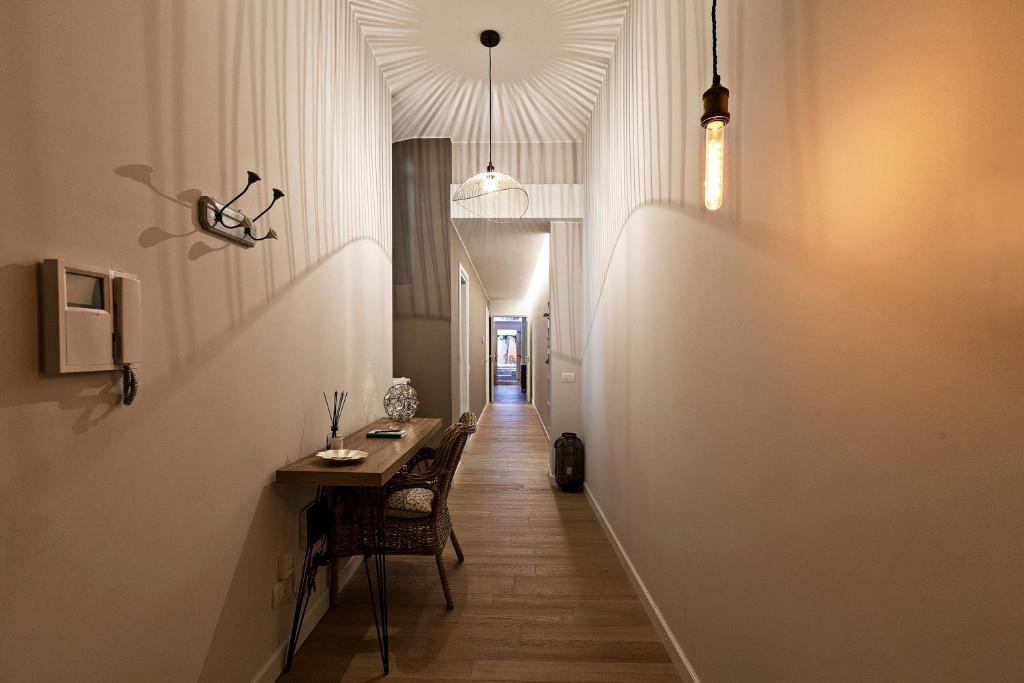a hallway with a table and chairs in a building at Tiaré Home Milano in Milan