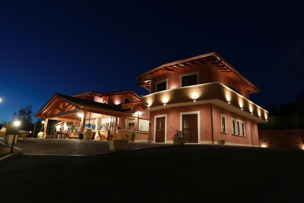una casa grande con luces encendidas por la noche en Agriturismo ciociaro " il colle " HOTEL RISTORANTE en Ceprano