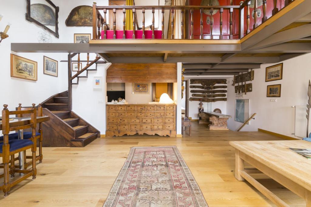 a large living room with a staircase and wooden floors at Residence SanMarco in Venice