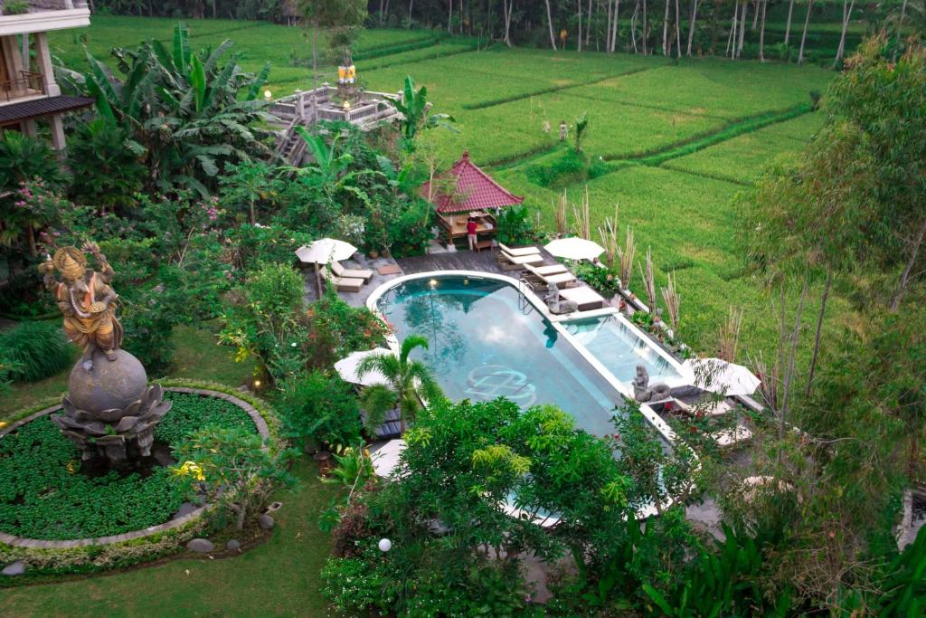 an aerial view of a garden with a swimming pool at Om Ham Retreat and Resort in Ubud