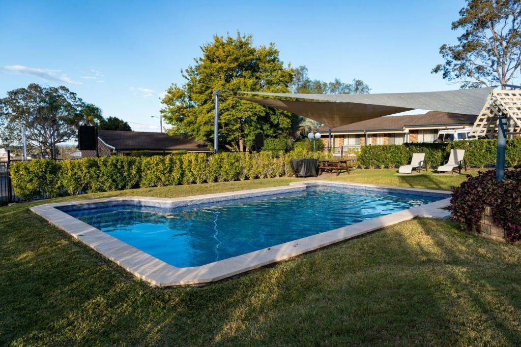 a swimming pool in the yard of a house at Old Maitland Inn in Maitland