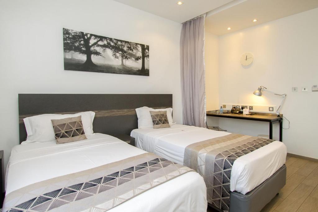 Postel nebo postele na pokoji v ubytování Imperial Hotel Express