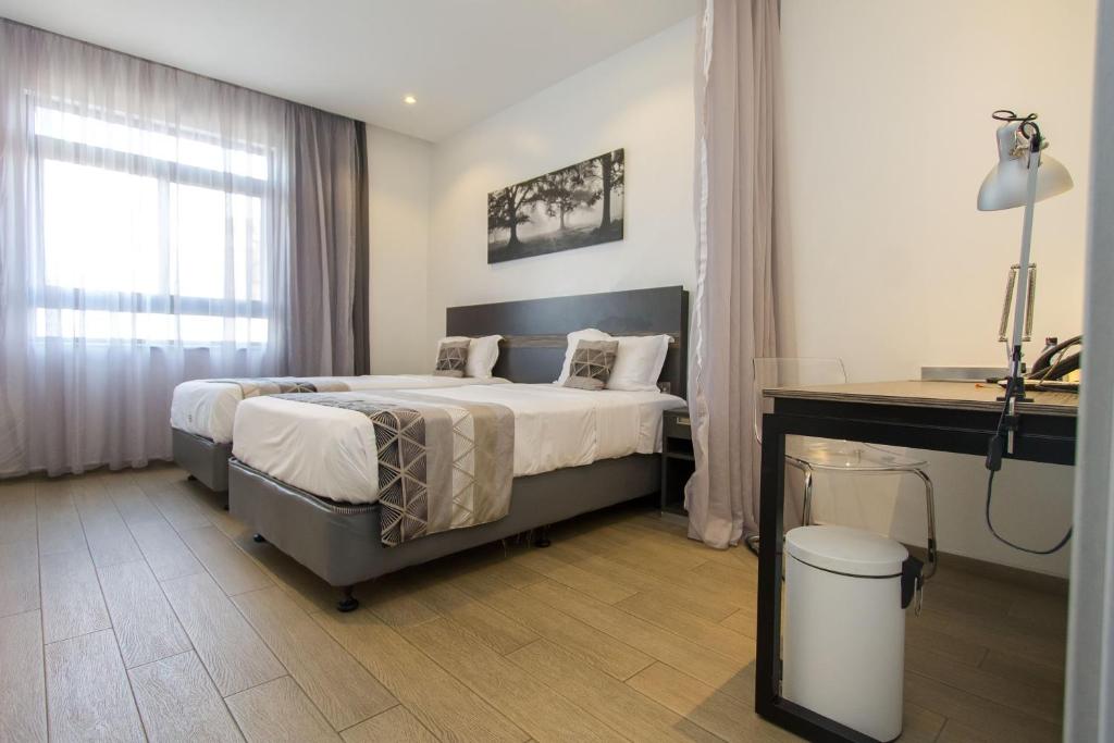 Postel nebo postele na pokoji v ubytování Imperial Hotel Express