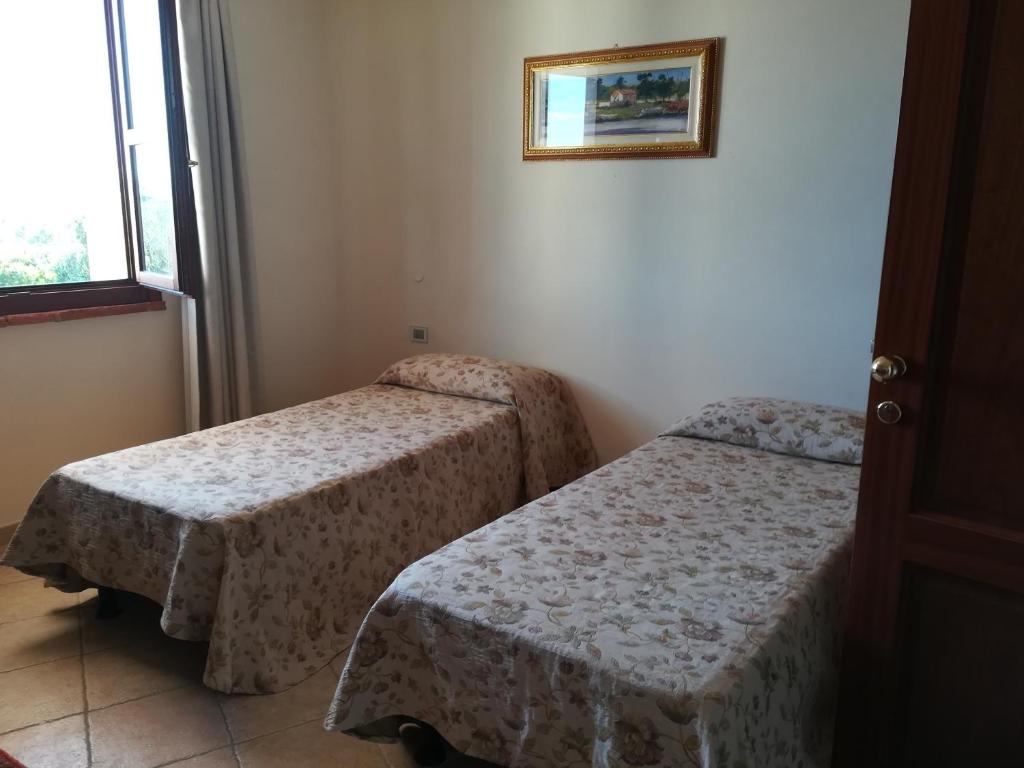 Postel nebo postele na pokoji v ubytování Villa Loreto