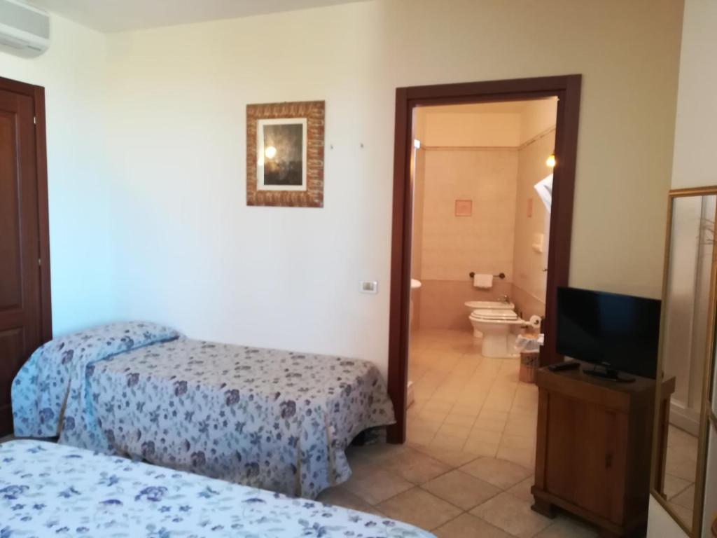 Postel nebo postele na pokoji v ubytování Villa Loreto