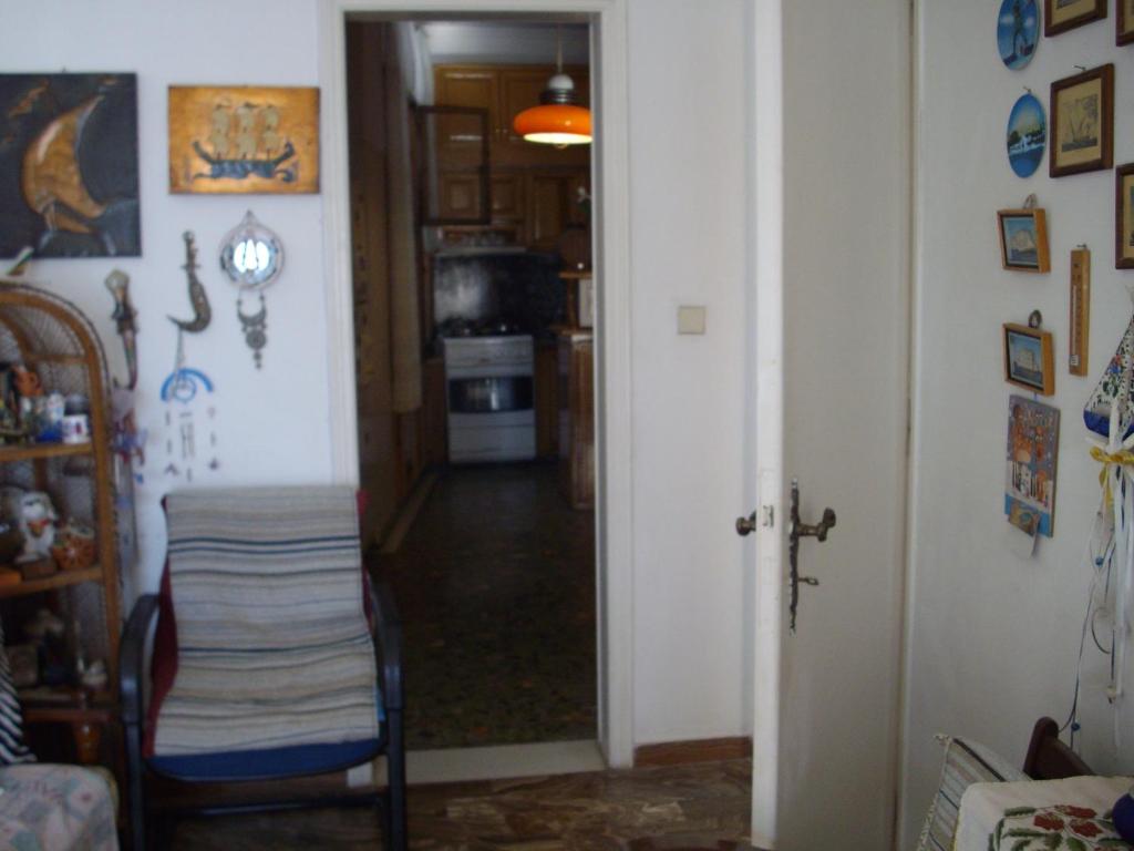 a room with a hallway with a table and a door at Anna in front of the sea Apartment in Sitia