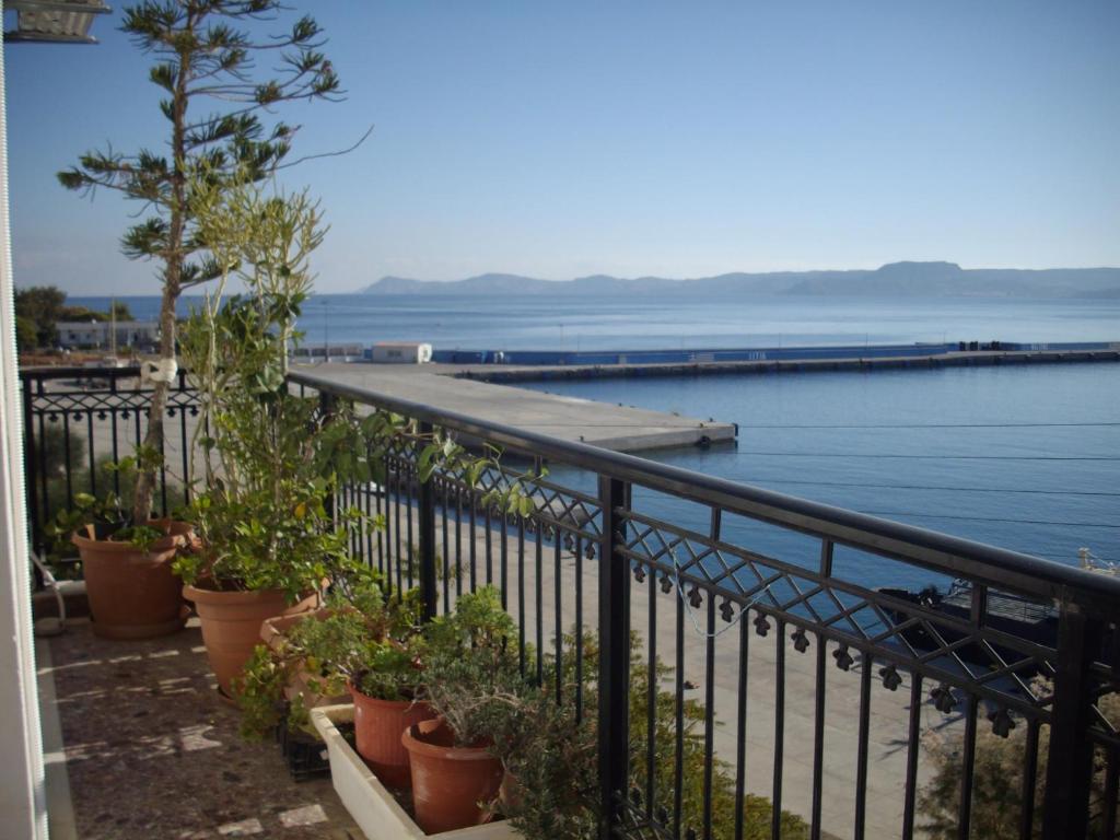 a balcony with a view of a body of water at Anna in front of the sea Apartment in Sitia