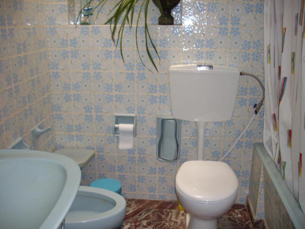 a bathroom with a toilet and a sink at Anna in front of the sea Apartment in Sitia
