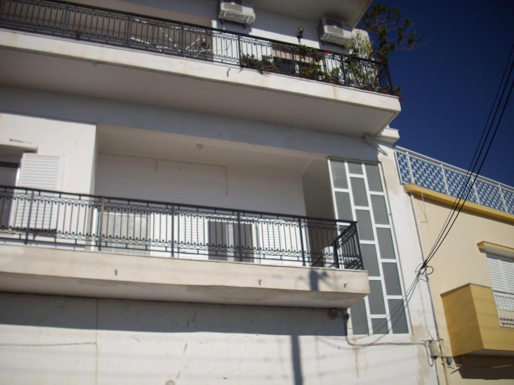 a balcony on the side of a building at Anna in front of the sea Apartment in Sitia