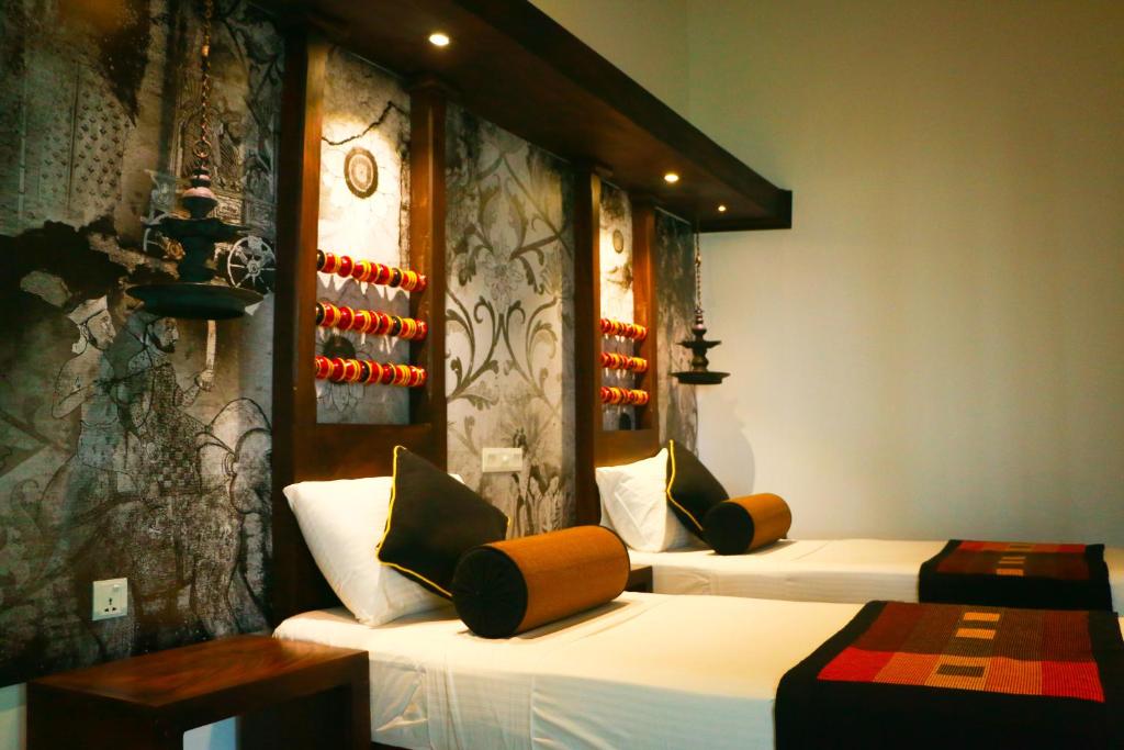 Postel nebo postele na pokoji v ubytování Serendib Signature Resort